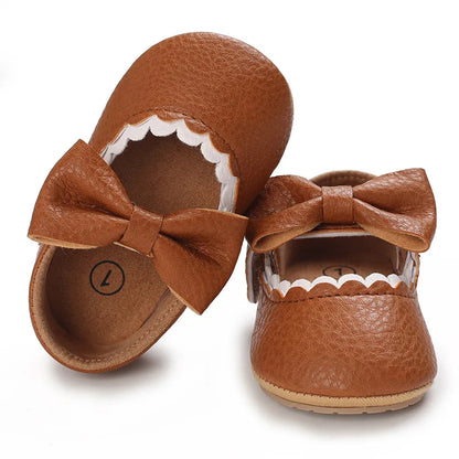 Indulge your little one's feet with our adorable Mary Jane baby shoes in a selection of sweet colors. Perfect for newborns through 18 months old, choose from white, black, apricot, and brown to match any outfit.