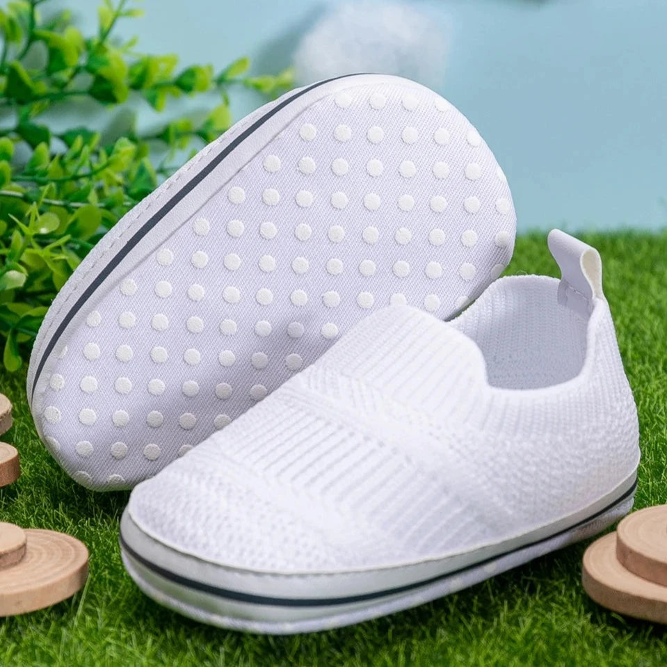 Easily breathable and featherlight infant shoes in shades of pink, white, and grey; perfect for newborns up to 18 months of age.