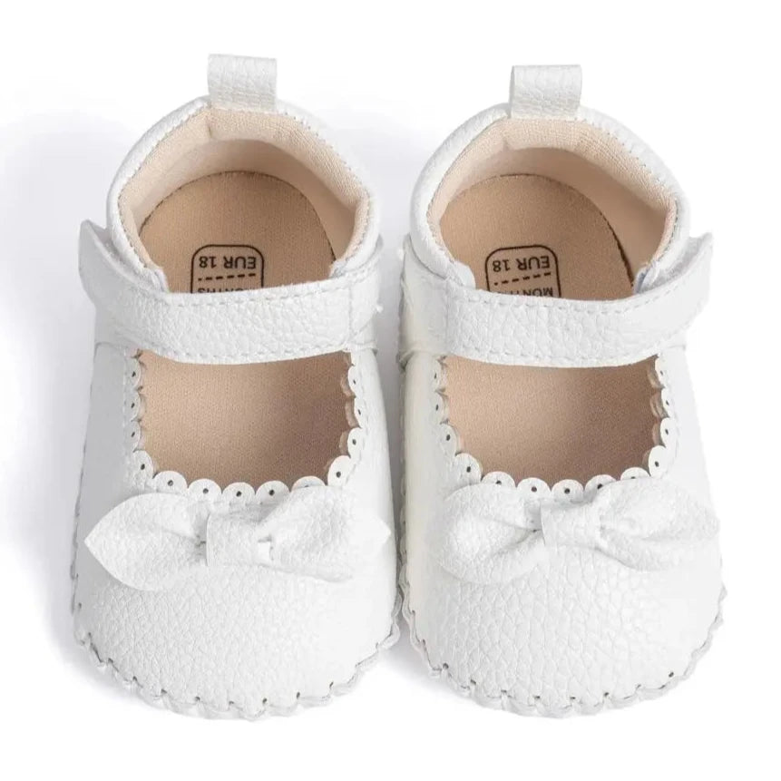 Designed with both style and comfort in mind, these Little Bow-Tie baby shoes are available in a variety of colors and sizes for newborns up to 18 months old. Each pair is meticulously crafted to provide a snug and secure fit for your little princess. Whether you're dressing them up for a special occasion or keeping them comfy for everyday wear, these shoes are the perfect choice for your little one.