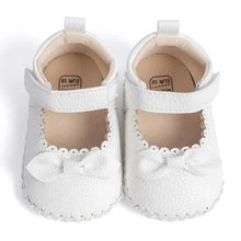 Load image into Gallery viewer, Designed with both style and comfort in mind, these Little Bow-Tie baby shoes are available in a variety of colors and sizes for newborns up to 18 months old. Each pair is meticulously crafted to provide a snug and secure fit for your little princess. Whether you&#39;re dressing them up for a special occasion or keeping them comfy for everyday wear, these shoes are the perfect choice for your little one.
