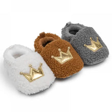 Load image into Gallery viewer, These cozy, snuggly slippers are fit for a royal baby! Made with fluffy teddy bear fabric to keep little toes warm and toasty. Available in sizes for newborns up to 18 months old. Choose from white, grey, or brown.
