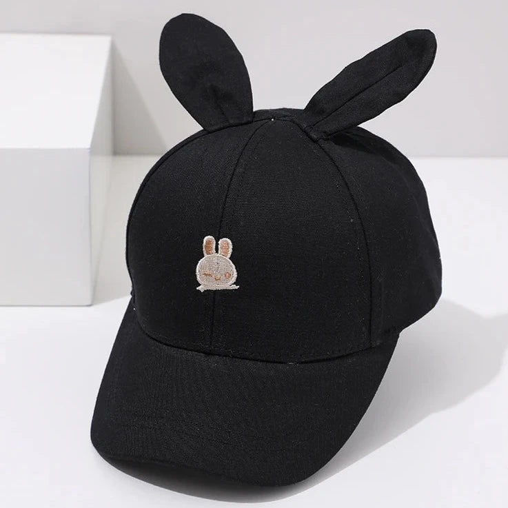 Introducing the adorable Bunny Ears Baseball Hat, available in pink, black, white, and khaki for children newborn to 3 years old! Perfect for adding a touch of cuteness to any outfit.