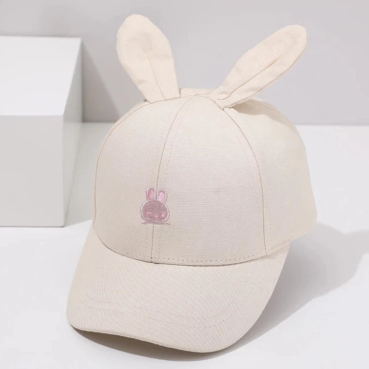 Introducing the adorable Bunny Ears Baseball Hat, available in pink, black, white, and khaki for children newborn to 3 years old! Perfect for adding a touch of cuteness to any outfit.