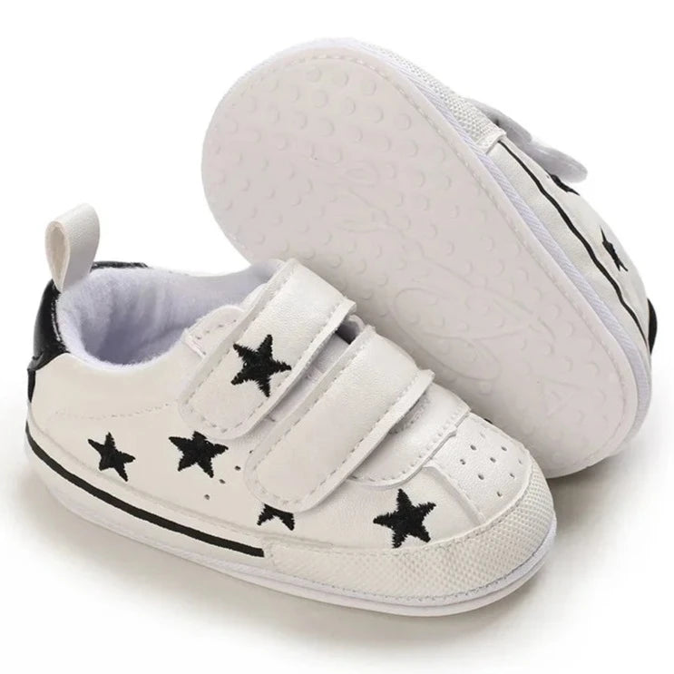 Elevate your little one's style with our Sporty Star Sneakers, designed for newborns to 18 months. These breathable, non-slip shoes feature a crisp white color and sleek black stars, perfect for budding athletes.4107974967504