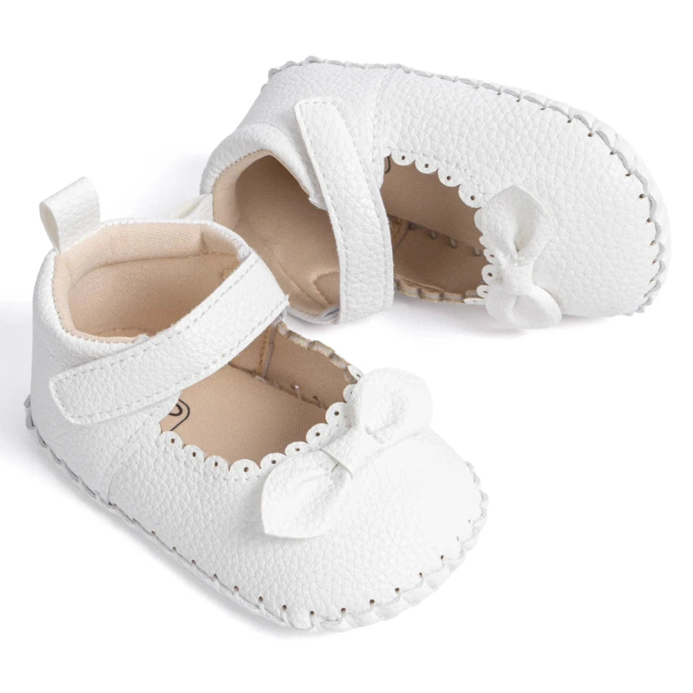 Designed with both style and comfort in mind, these Little Bow-Tie baby shoes are available in a variety of colors and sizes for newborns up to 18 months old. Each pair is meticulously crafted to provide a snug and secure fit for your little princess. Whether you're dressing them up for a special occasion or keeping them comfy for everyday wear, these shoes are the perfect choice for your little one.