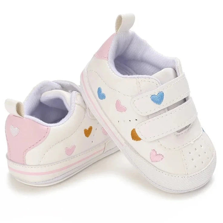 Experience the ultimate in comfort and style with our white embroidered hearts baby sneakers! Adorned with colorful hearts, these sneakers are perfect for babies aged newborn to 18 months. Stay comfortable and steady on your feet with their breathable and non-slip design.