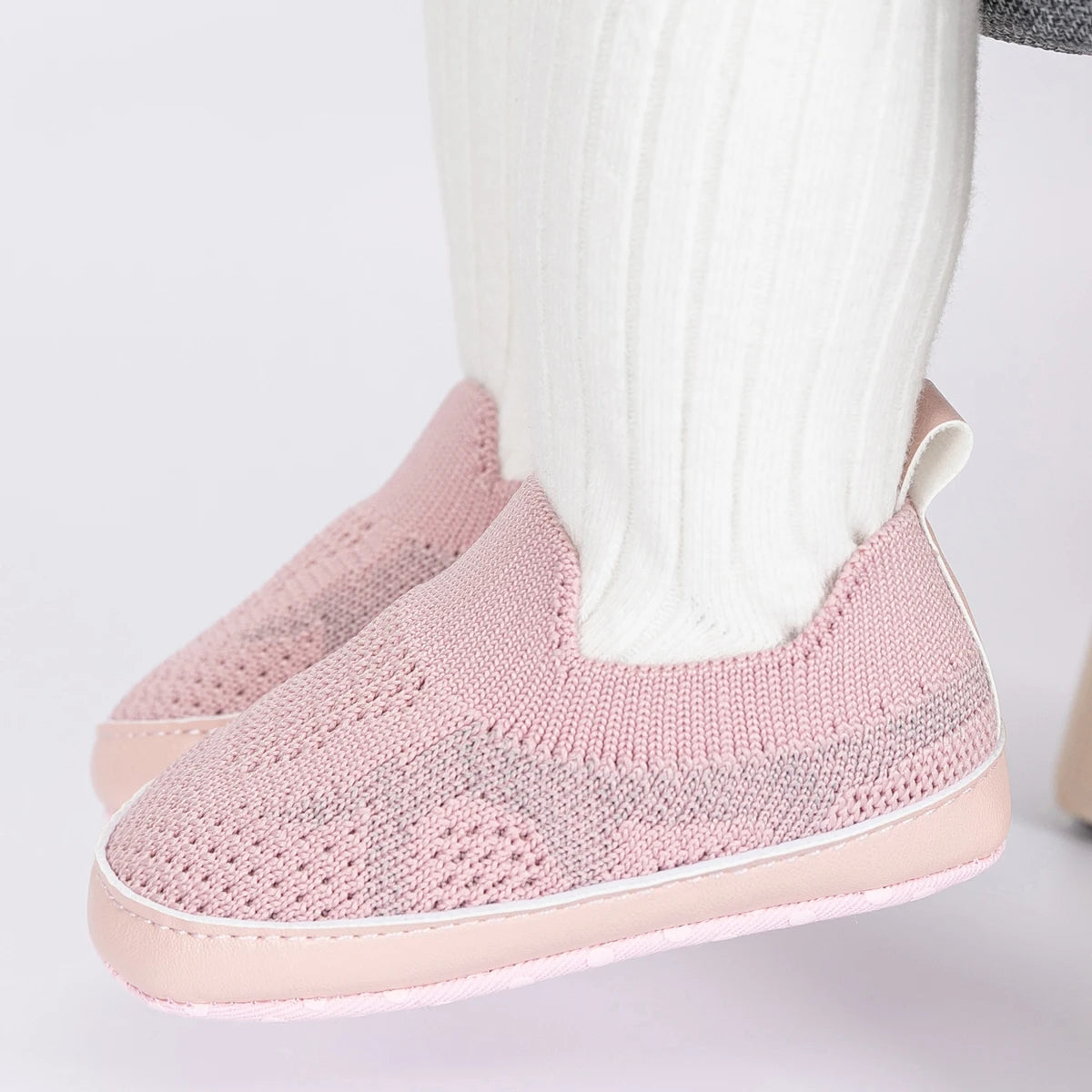 Easily breathable and featherlight infant shoes in shades of pink, white, and grey; perfect for newborns up to 18 months of age.