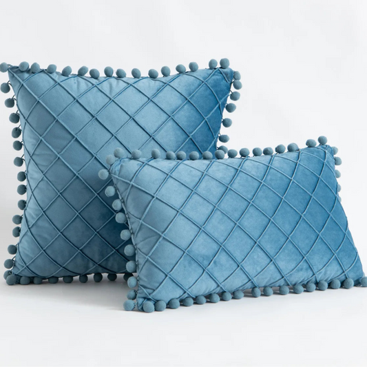 Elevate the look of your children's bedroom or playroom with the unique Stone Blue Pompom Pillow Cover. Designed with faux velvet fabric on both sides, this decorative throw pillow cover offers a plush, comfortable feel. Make a statement with this luxurious accent piece that combines both comfort and style.