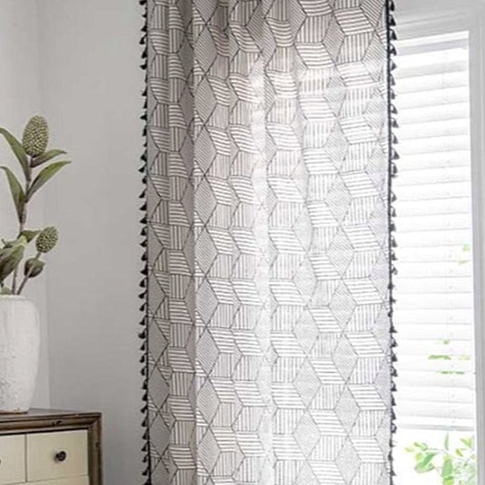 Transform any room in your home with this black and white geometric tassel curtain panel(1)! Woven from cotton and linen, this one-of-a-kind curtain adds texture and depth with its stunning tassel pattern. Choose between a grommet, pull pleated or hook hanging application for easy setup. Experience its beauty and add a unique twist to your decor now! Machine washable. Not included: Tieback, tracks and beads.