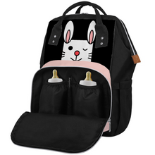 Load image into Gallery viewer, Multifunctional waterproof black and pink little bunny diaper bag. Material: Waterproof polyester. Size:  Length 9.8 x 9.s x 15 inches (25cm x 23.5cm x 38cm). Black adjustable straps. This bag has a side bag, front zippered pocket, small storage box, multi-pocket design, side zipper. This mommy bag can be used as a backpack or handbag. Great as a gift for a new mother or father.
