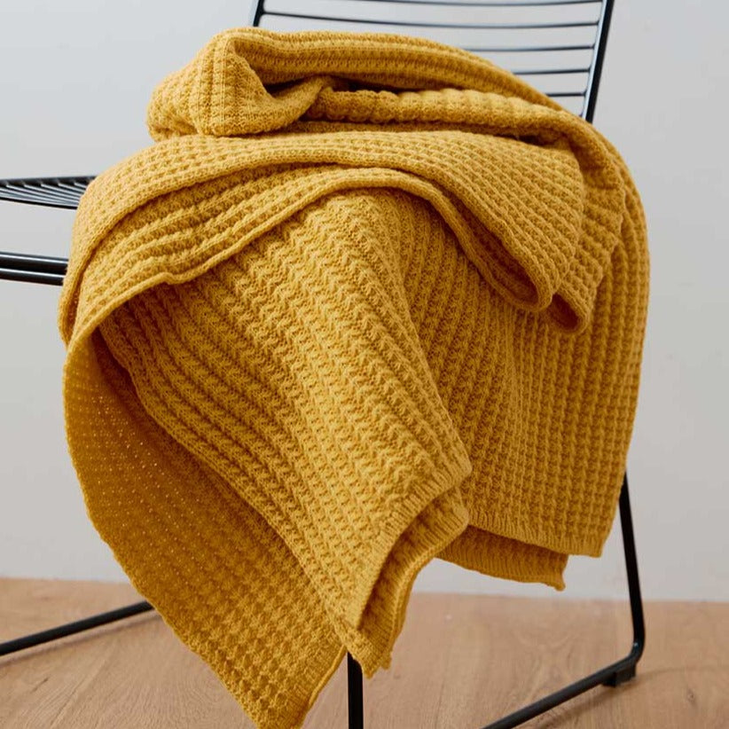 Bring the warmth of comfort with a touch of style to any room with this classic yellow throw blanket. Knitted from lightweight material, it's soft against the skin for luxurious snuggling of your little one. Enjoy cozy nights all year round in luxurious softness.  Size: 50 x 62 inches (127cm x 157cm) Material: 100% High Quality Acrylic Machine Wash: Color separate in a gentle cold water cycle. Tumble dry low, Low iron.