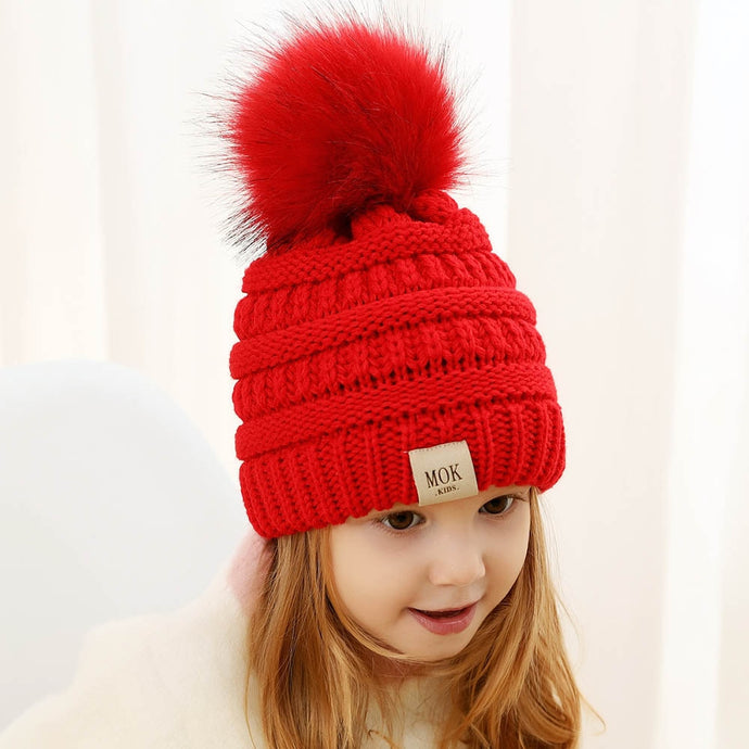 Keep your kid warm with this red beanie hat. Great for children age 1 to 7 years. This knitted cotton hat comes in red, yellow, beige, pink, black, white and grey.