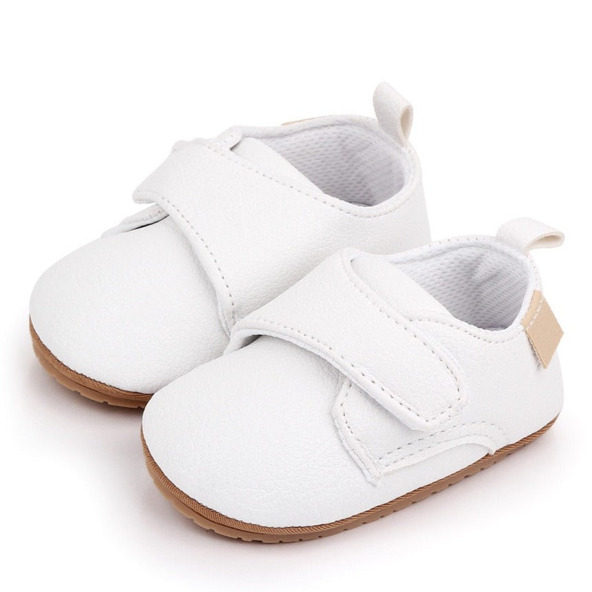 Little walker baby shoes in white for your newborn to 18-month-old. these leather shoes come in black, brown, blue, beige and white.  Material: leather Outsole Material: Rubber Feature: Anti-Slip, Flat, Breathable, Light Weight Fashion Element: Butterfly-knot Closure Type: Hook & Loop