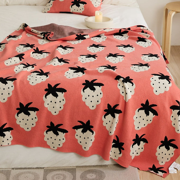 This strawberry knitted blanket adds the perfect burst of color to any kids bedroom or nursery. Keep them cozy with the knitted decorative strawberries in shades of pink, green and brown.  Size: 51.18 x 62.99 inches (130cm x 160cm) Material: 100% cotton Feature: Anti-pilling.