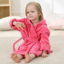 Load image into Gallery viewer, The perfect dinosaur hooded hot pink bathrobe for kids ages 2 to 6 years. This bathrobe comes in blue, green and pink. Material: Cotton. Fabric Type: Worsted.
