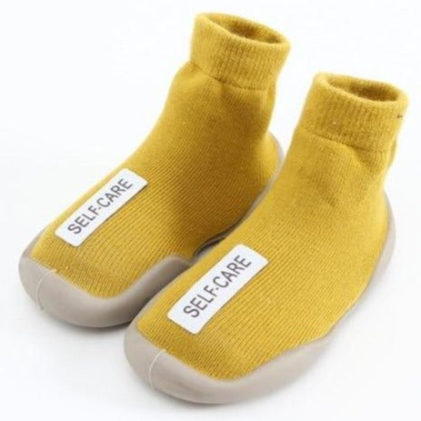 Super cool and sturdy indoor yellow non-skid baby and toddler shoes for your first time walker. These super cool shoes come in yellow, black, red, grey and brown. This kids footwear is for ages 6 months to 4 year. Free shipping.