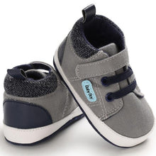 Load image into Gallery viewer, Super cool grey sneakers for your new baby or first time walker. Soft sole and anti-slip. These canvas shoes are for babies ages newborn to 18 months and come in blue, beige, brown and grey. Free Shipping.
